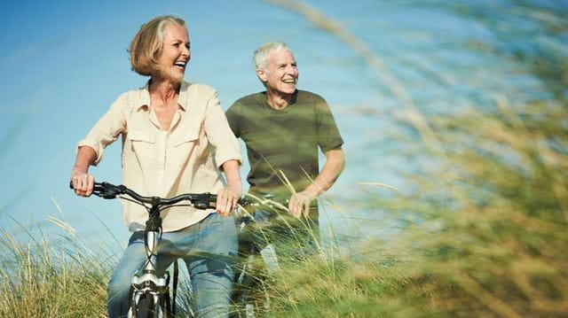 Retirement planning tips elderly couple riding bikes